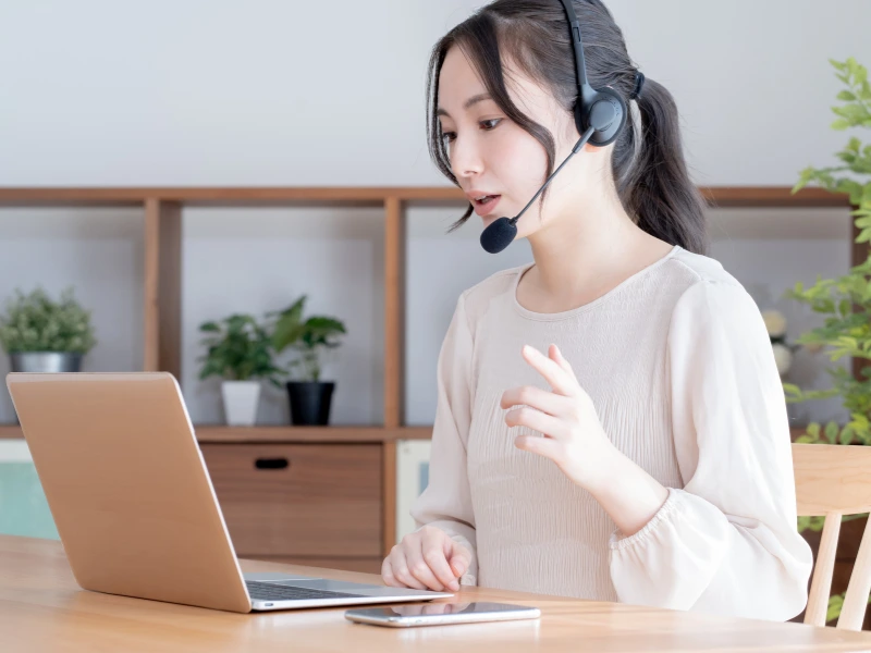 Woman wearing a headset on a laptop call showing how WebRTC works
